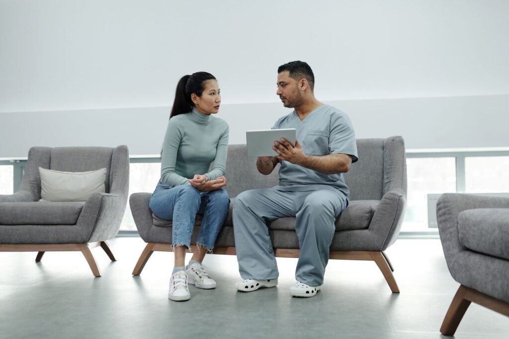 Doctor talking with a patient while holding a tablet