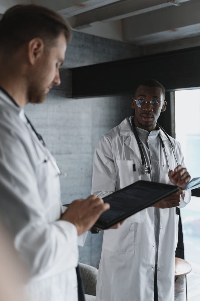 Two doctors reviewing patient information on a tablet
