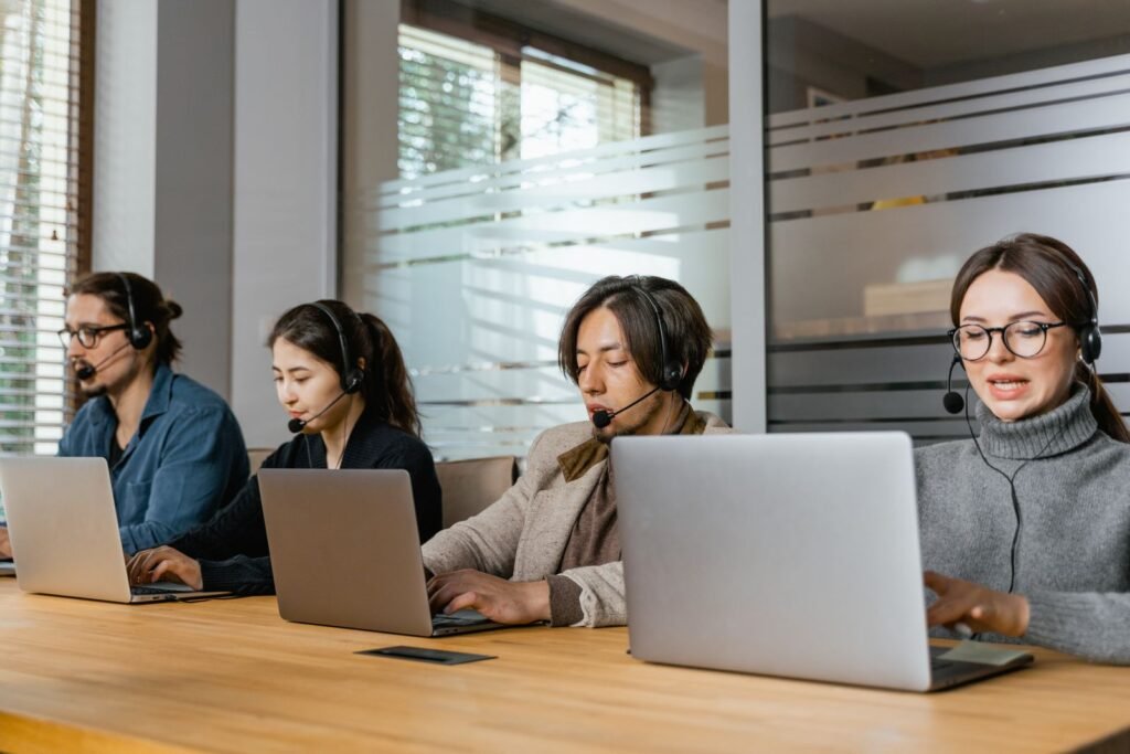 Customer support team working on laptops